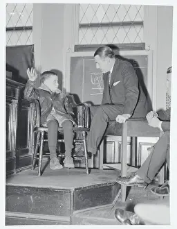 Boy Speaking to Coroner with Arm Raised