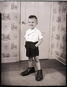 Boy Standing in Oversized Shoes
