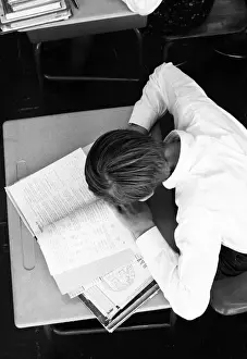 Desk Prints: Boy studying at school desk, overhead view