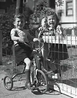 Boy on tricycle w / girl