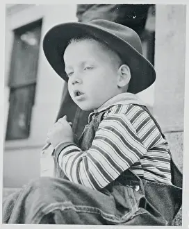 Boy Wearing Hat and Eating Treat