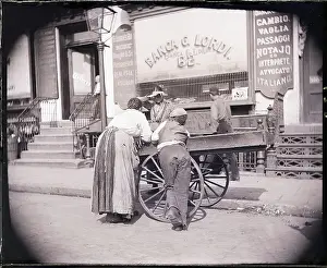 Peddler Prints: Boy and Woman Lean on Hucksters Pushcart