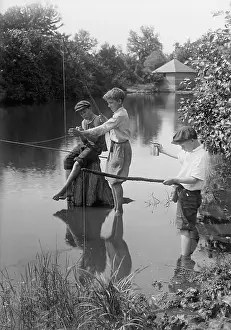 10 12 Years Prints: Boys (10-12 years) fishing in river. August 11, 1925