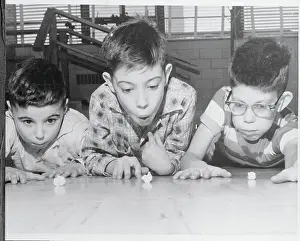 Boys Blowing Paper Scraps