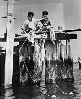 Two Boys On A Dock Fishing