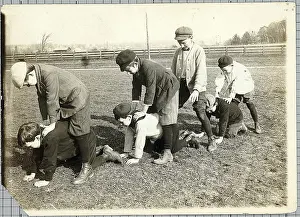 Boys in a Field Playing Leapfrog