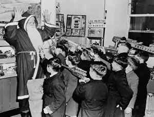 Boys Holding up Santa Claus with Toy Guns