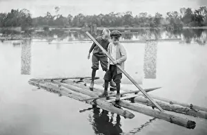 Paddling Prints: Two Boys on Their Homemade Log Raft