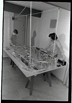 Boys Playing with Suspended Train Set