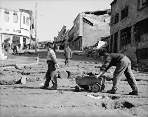Earthquake Prints: Boys Push Wagon Across Cracked Street
