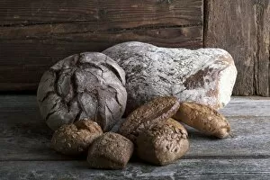 Bread loaves and rolls on a rustic wooden surface