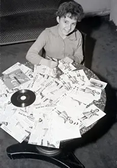 Autographing Prints: Brenda Lee Busily Autographs Photos