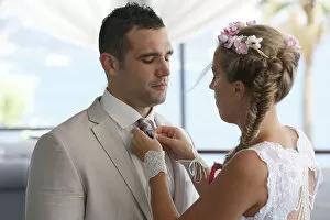 Images Dated 9th August 2014: Bride adjusting the grooms tie