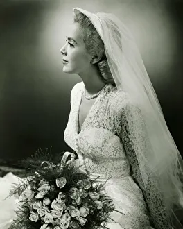 Aspirations Collection: Bride with bouquet posing in studio, (B&W), portrait