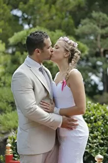Images Dated 9th August 2014: Bride and groom kissing