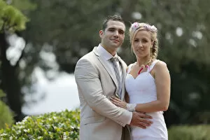 Images Dated 9th August 2014: Bride and groom posing in a park
