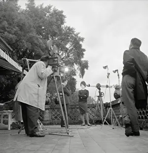Prints of (Original Caption). French film star Brigitte Bardot on the set of a movie being filmed, with Marcello Mastroianni as her co-star Captivating Moments: Brigitte Bardot in Action: Brigitte Bardot Standing on Movie Set
