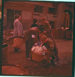 British Sentry Searching Through Basket of Bread