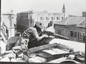 British Soldier Taking Aim with Weapon from Rooftop