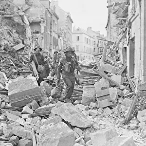 Caen Prints: British Tommy Carrying Stretcher Through Wreckage