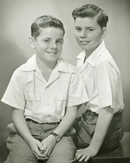 Short Sleeved Prints: Brothers (8-9) (10-11) sitting in studio, smiling, (B&W), portrait