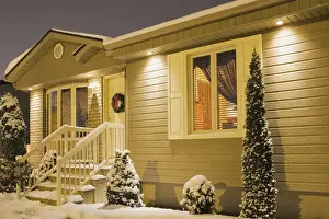 Realty Prints: Bungalow style residential home illuminated in winter at dusk with Christmas decorations