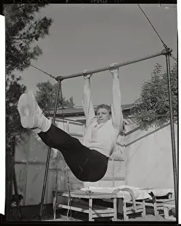 Burt Lancaster Swinging on Bar