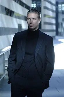 Suit Prints: Business man wearing a dark suit in front of a bank building