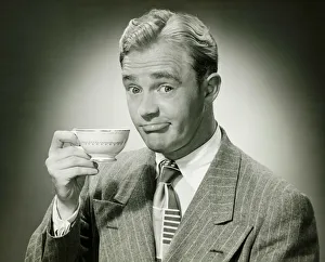 35 39 Years Collection: Businessman holding ceramic cup, (B&W), portrait