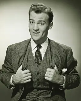 Waistcoat Prints: Businessman holding thumbs in waistcoat, smiling, (B&W), portrait