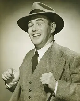 Waistcoat Prints: Businessman holding thumbs in waistcoat, smiling, (B&W), portrait