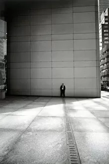 Businessman leaning against wall