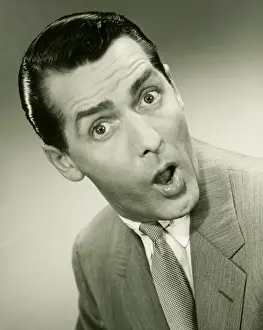 Raised Eyebrow Prints: Businessman looking surprised, posing in studio, (B&W), portrait