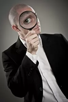 Images Dated 1st December 2011: Businessman with magnifying glass