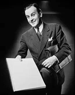 Raised Eyebrow Prints: Businessman presenting notebook, (B&W), portrait