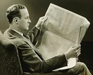 35 39 Years Collection: Businessman reading newspaper, (B&W)