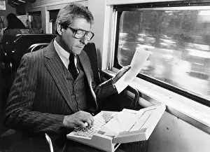 Typing Prints: Businessman Using Early Laptop