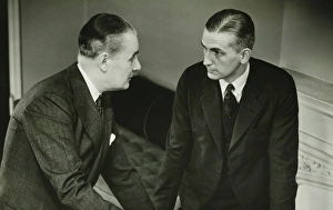 35 39 Years Collection: Two businessmen leaning on desk, talking, (B&W)