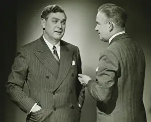 50 59 Years Prints: Two businessmen talking in studio, (B&W), portrait