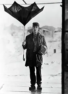 Raincoat Prints: Buster Keaton Holding Broken Umbrella in Steamboat Bill, Jr