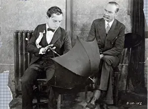 Buster Keaton Holding Umbrella Inside