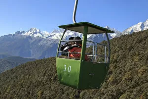 Images Dated 11th November 2016: Cable Car on foreground with some tourists inside and Jade Dragon Snow Mountain on foreground