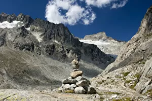 Cairn in Baechlital valley in front of Gross Diamentstock Mountain and Baechli Glacier, Bernese Alps, Switzerland