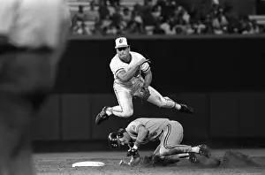 Cal Ripken Jr. leaps over player while throwing baseball