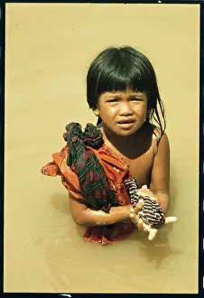Cambodian Girl Washes Clothing