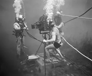 Submerged Prints: Camera Crew Filming a Diver