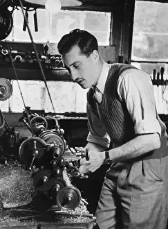 Prints of 2nd October 1948: Picture Post camera mechanic and photographer Len Carl Sutton at work on a camera. Original Publication: Picture Post - 4650 - How Picture Post Began - pub A Photographic Legacy: Camera Mechanic