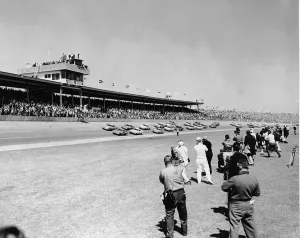 Prints of A group of news cameramen and photographers film a pack of cars racing during the Daytona 500 race at Daytona Speedway, Daytona Beach, Florida, 1960s. (Photo by R. Gates/Getty Images) Chasing Speed: Motorsport in Motion: Cameramen Filming Daytona 500 Auto Race