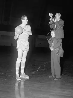 Shoulder Prints: Cameramen Photograph Basketball Player