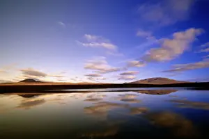 Canada, Yukon Territory, cumulus clouds reflected in Two Moose Lake in morning light